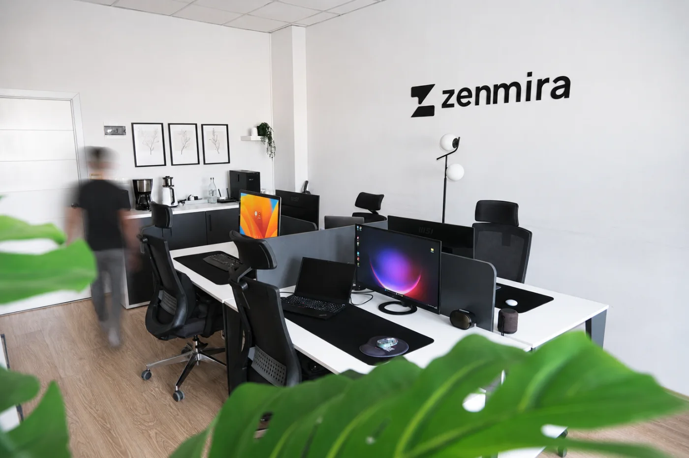 Developer desks and the shared kitchen corner of the office